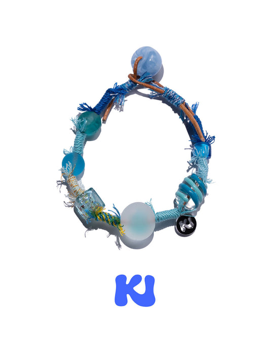 Beaded woven bracelet with round light-blue beads and blue tassels