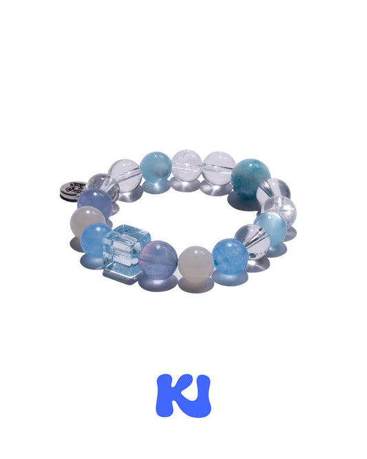 Stretch beaded bracelet with blue, white, and clear round beads plus a charm