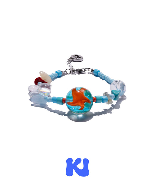 Charm bracelet with blue beads and large orange globe-style centerpiece bead