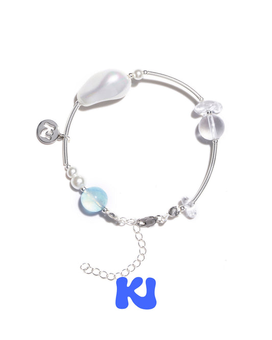 Crystal bracelet with silver-tone bangle and pale blue and iridescent bead charms