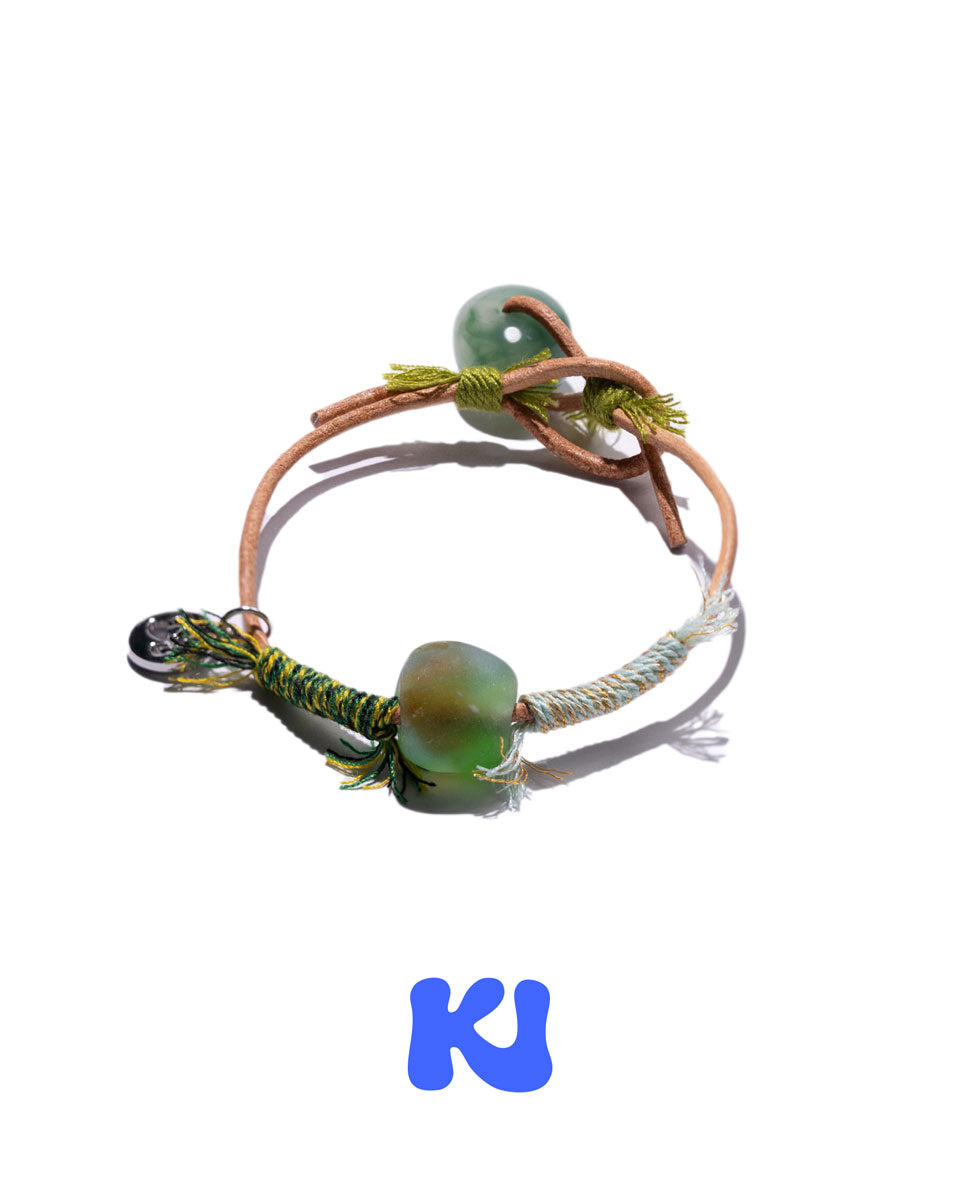 Moss Glade beaded charm bracelet with green beads and braided cord, adjustable loop