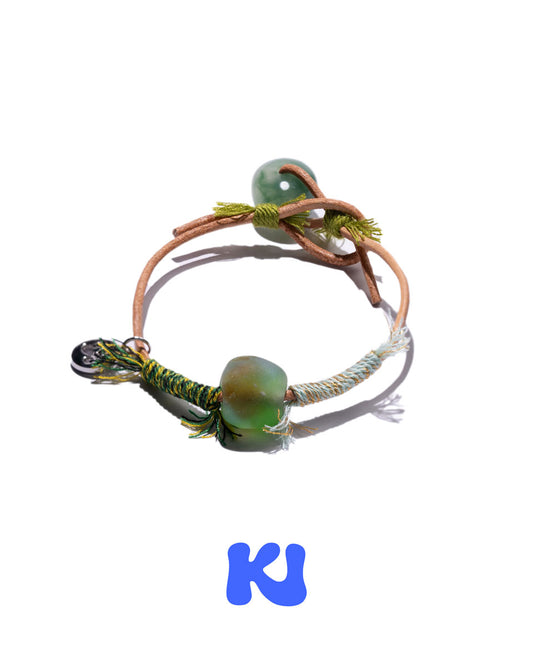 Moss Glade beaded charm bracelet with green beads and braided cord, adjustable loop