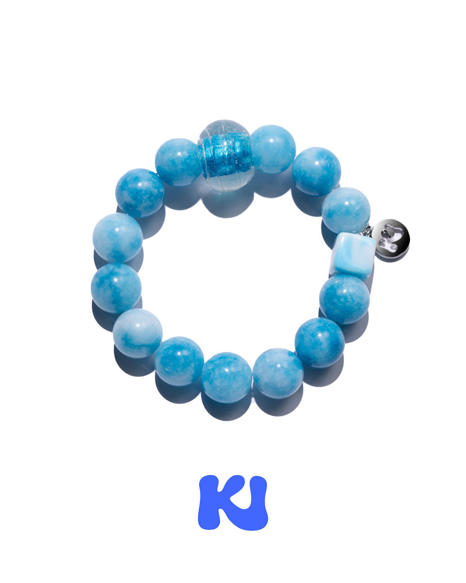 Blue beaded bracelet with round beads and clear spacer beads