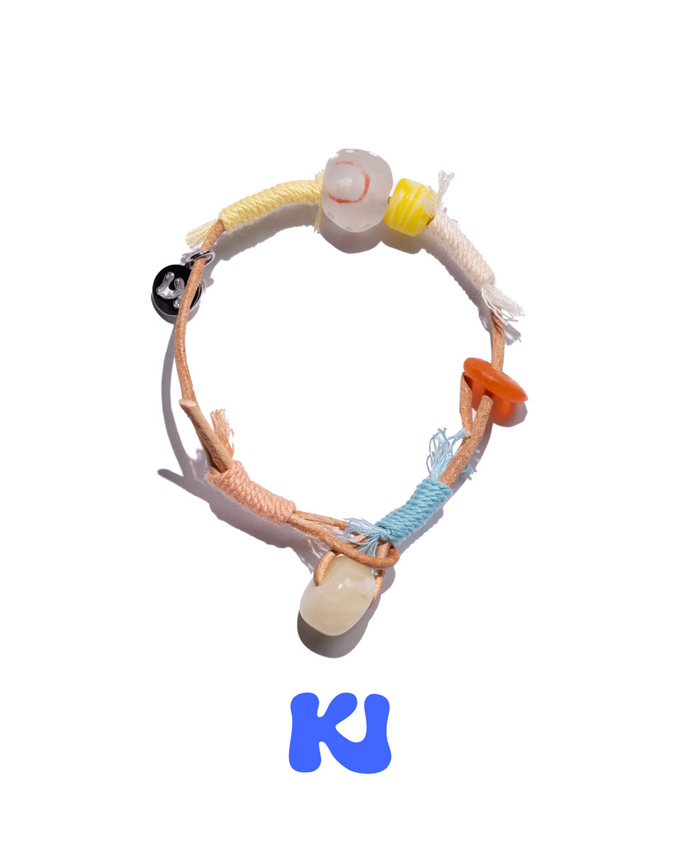 Multicolor rope bracelet with white beads and orange, blue, and yellow braided cords