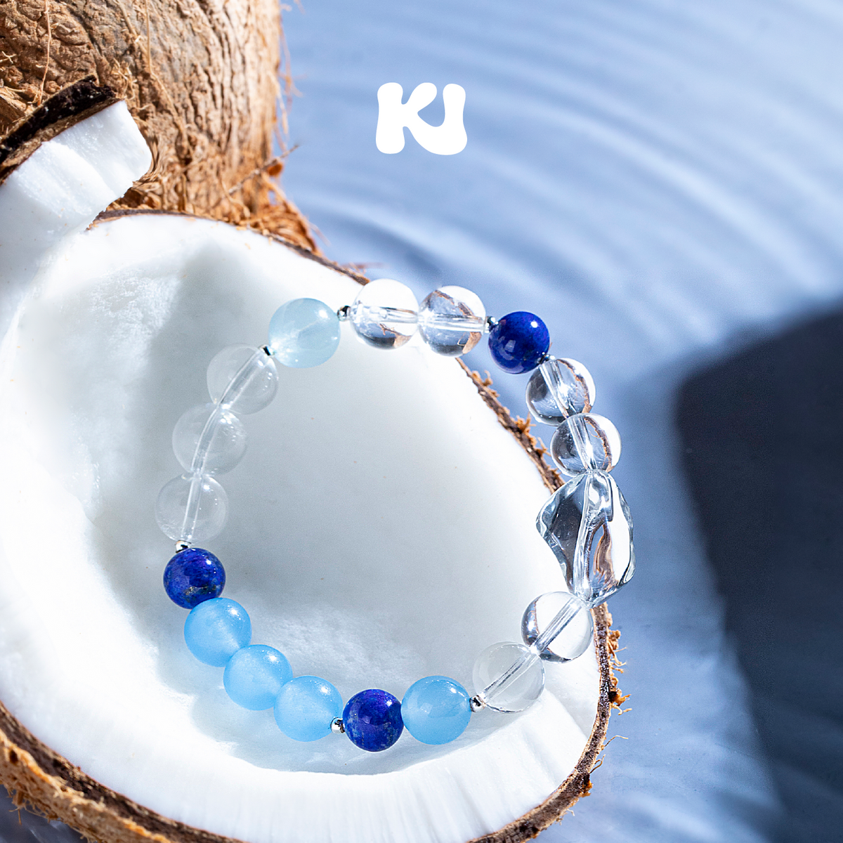 Blue and clear round crystal bead bracelet with dark blue lapis-style accents