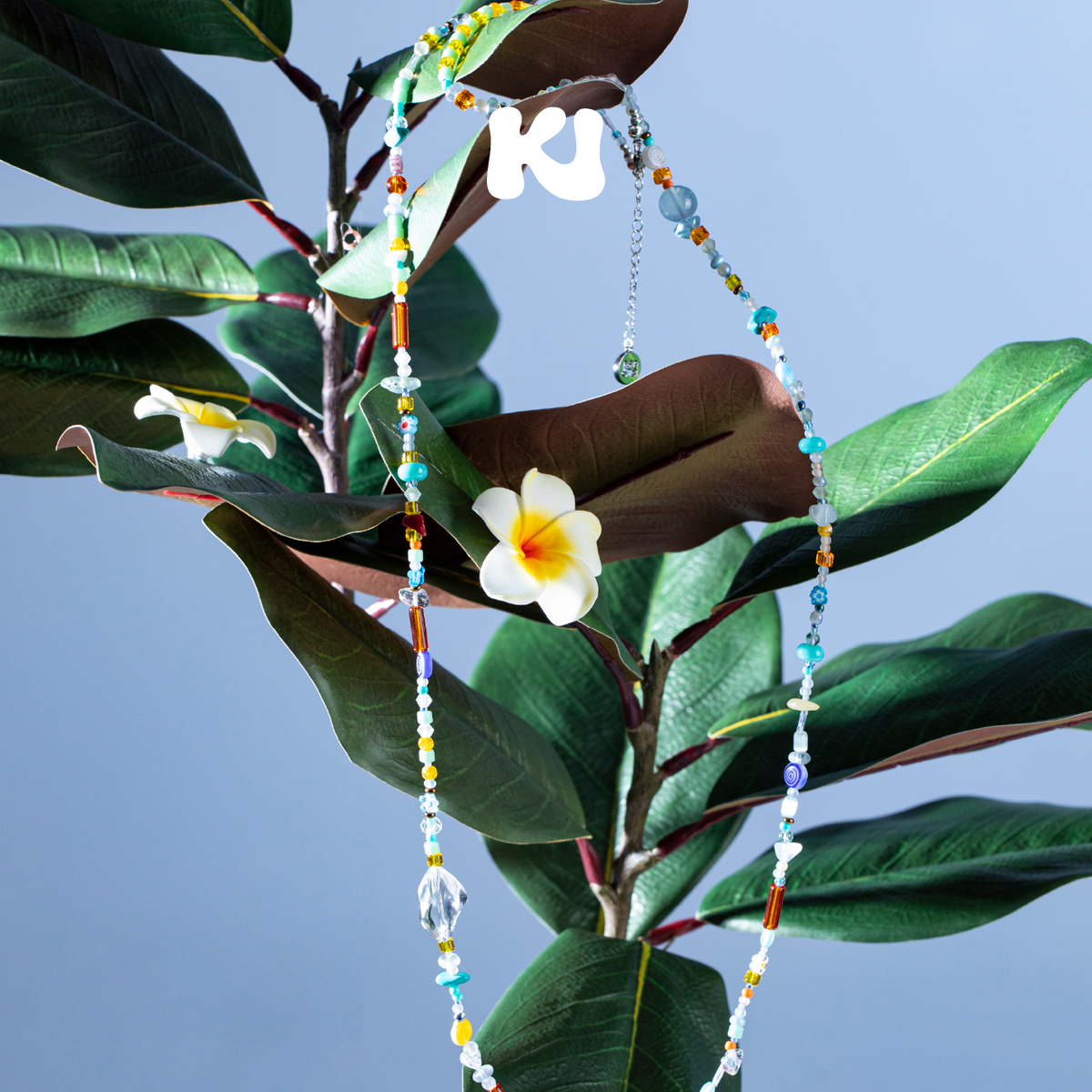 Multicolor seed bead and crystal necklace with long beads and white flower charm