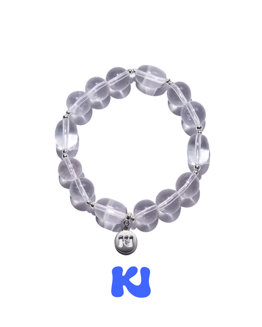 Clear beaded bracelet with silver-tone links and small round charm