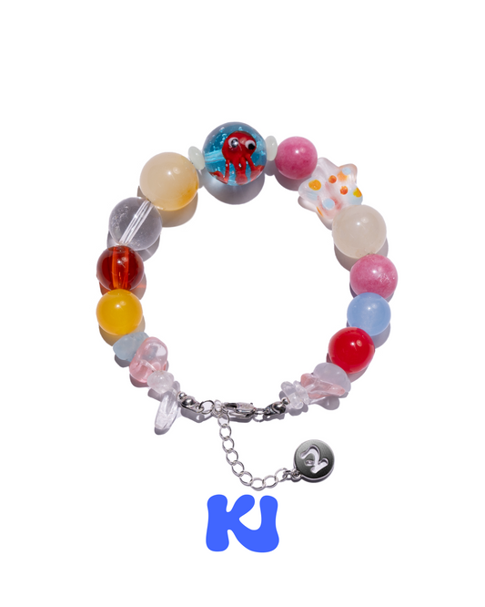 Colorful beaded bracelet with blue octopus face center and heart charm on chain