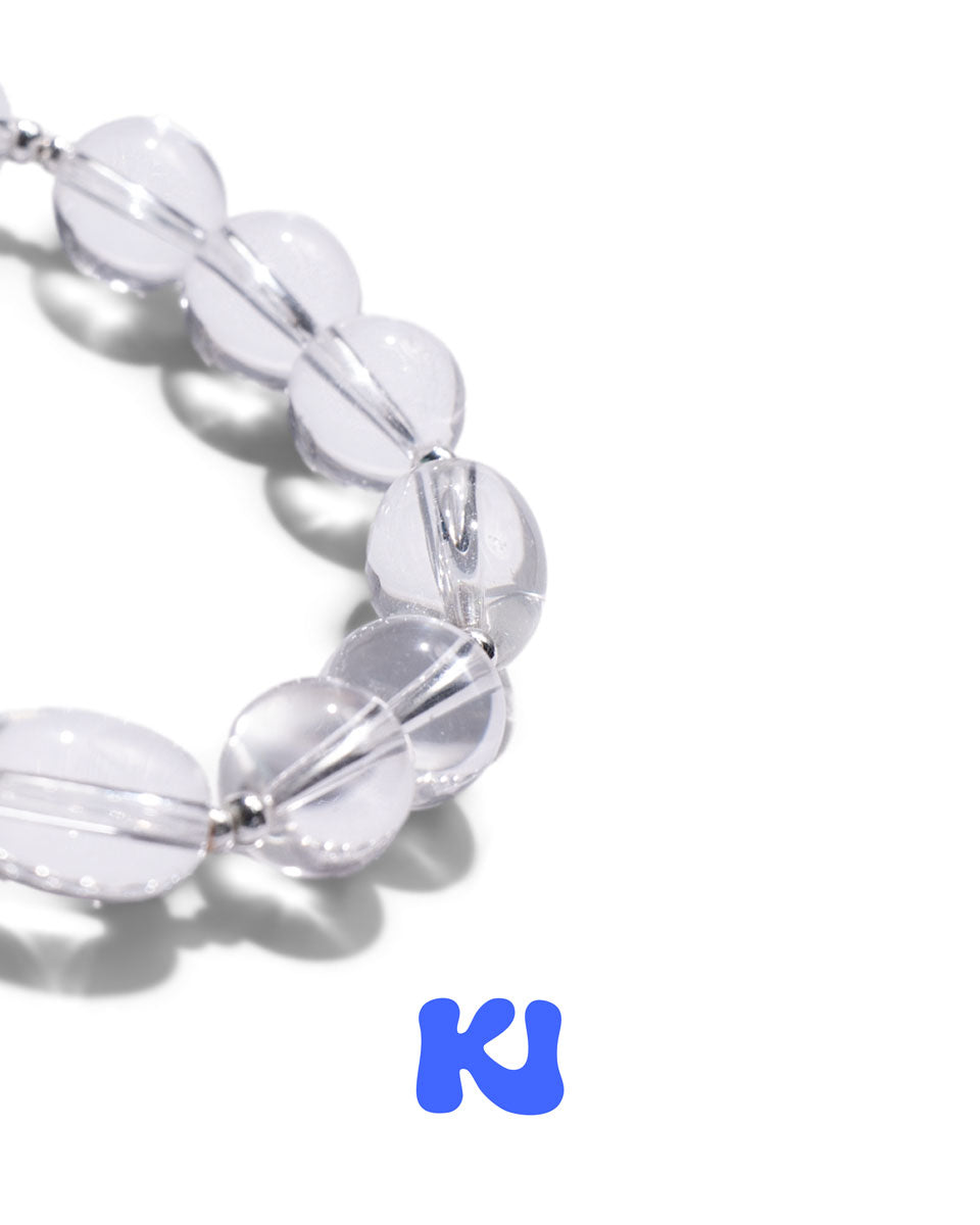 Clear oval bead bracelet close-up with glossy beads and silver-toned links
