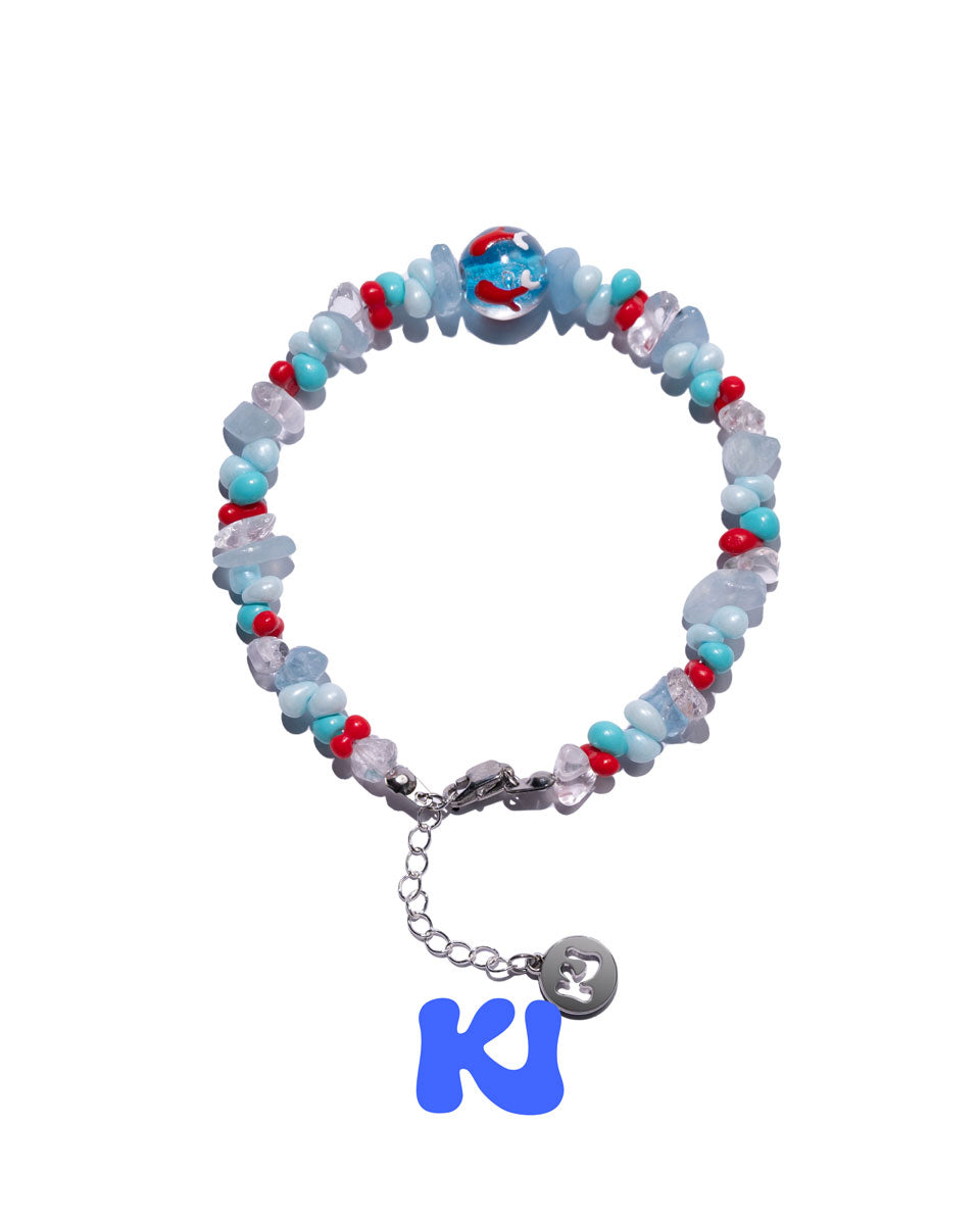 Beaded bracelet with light blue glass beads, red accents, and silver chain with round charm