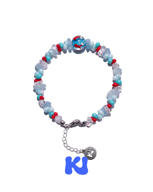Beaded bracelet with light blue glass beads, red accents, and silver chain with round charm