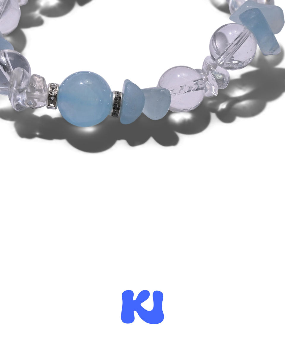 Close-up of light blue and clear beaded bracelet with oval center bead