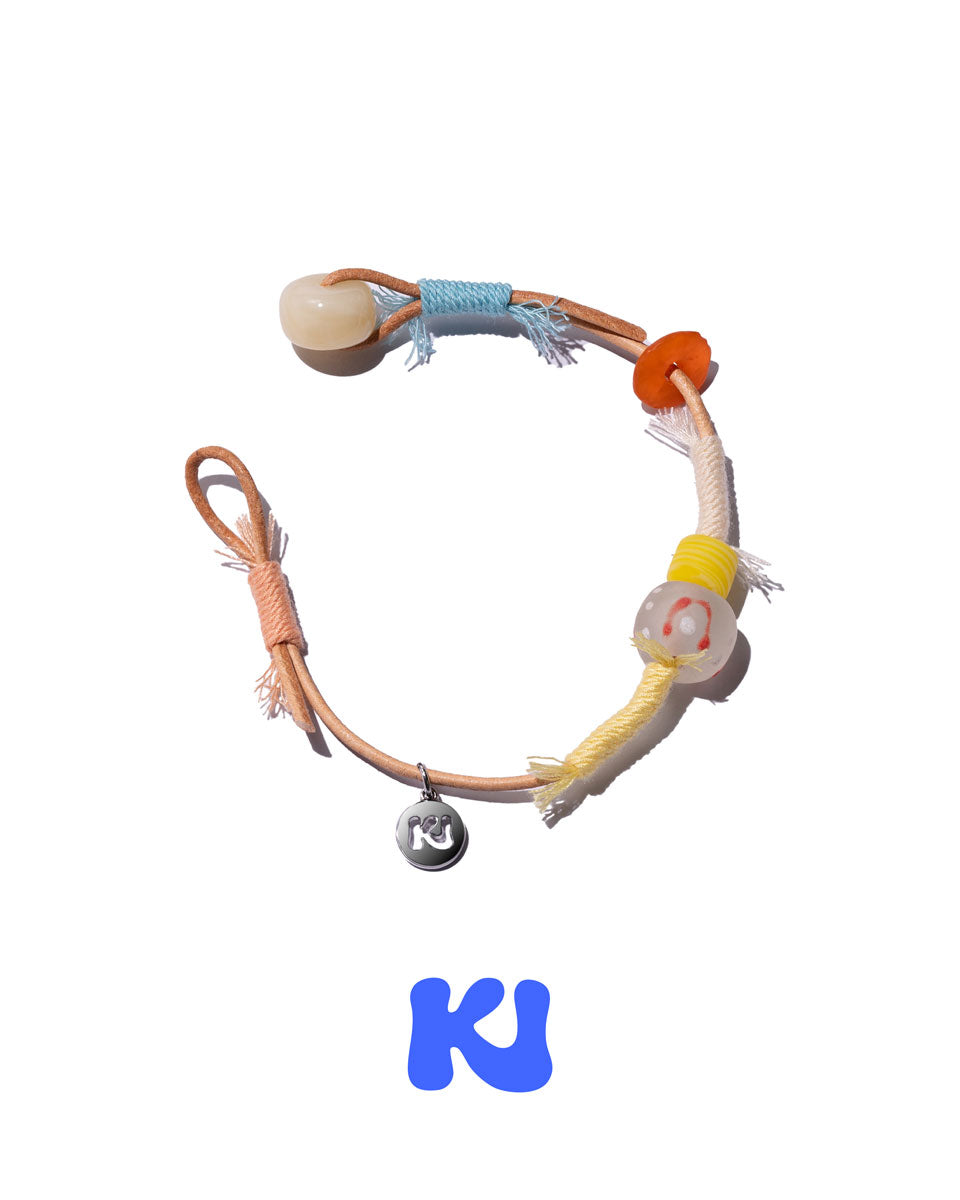 Rope bracelet with white, orange, and yellow beads and braided blue and brown cords