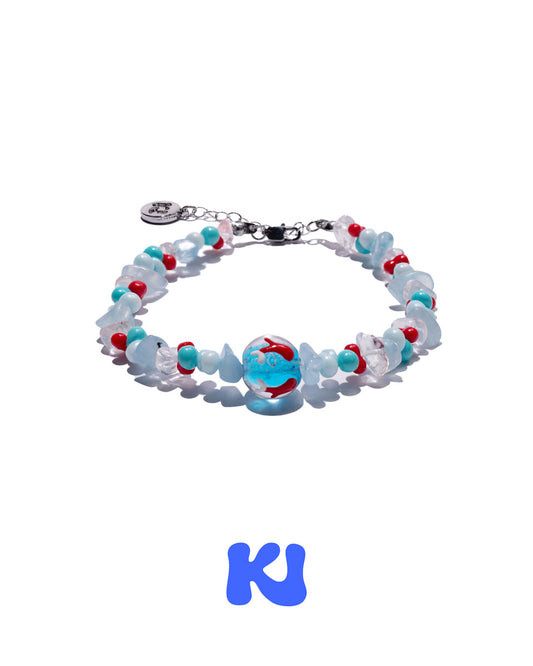 Beaded charm bracelet with large blue-red centerpiece bead and silver chain extension