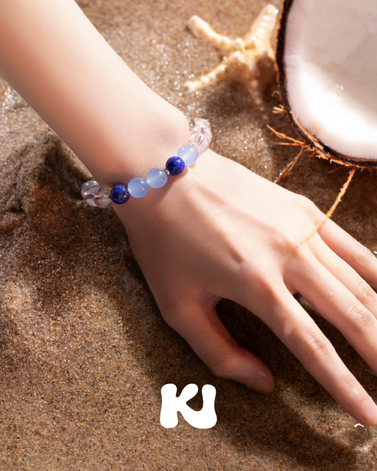 Blue lapis lazuli bead bracelet with silver spacers, close-up on hand