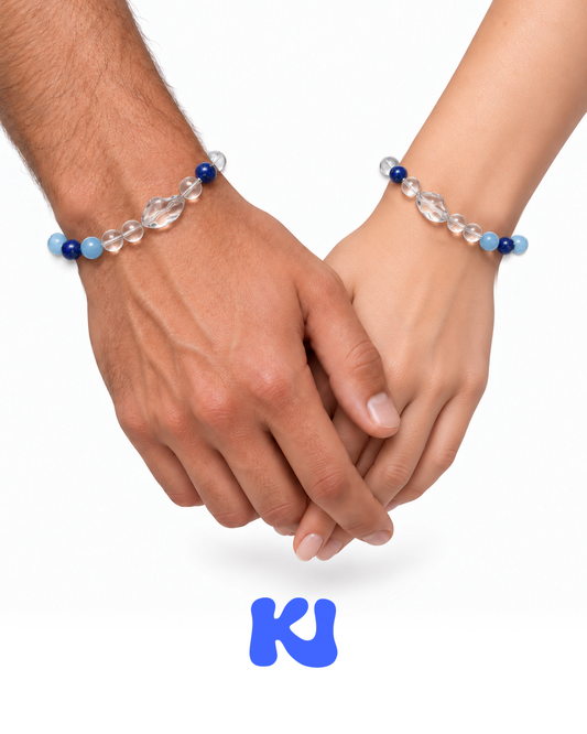 Pair of blue and clear beaded bracelets worn on two hands